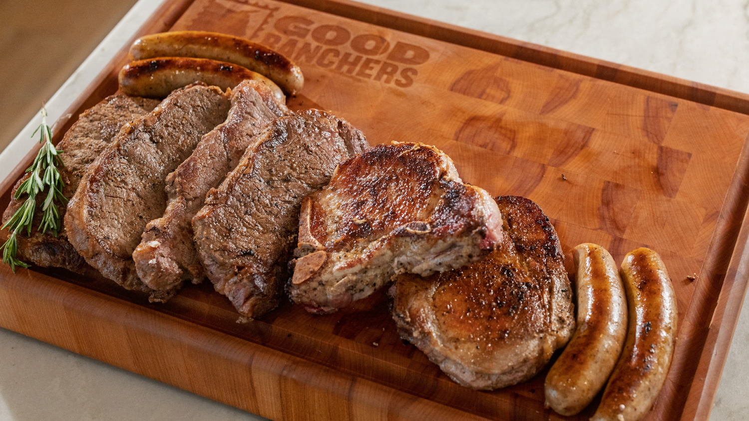 Steak and sausages on a wooden cutting board.